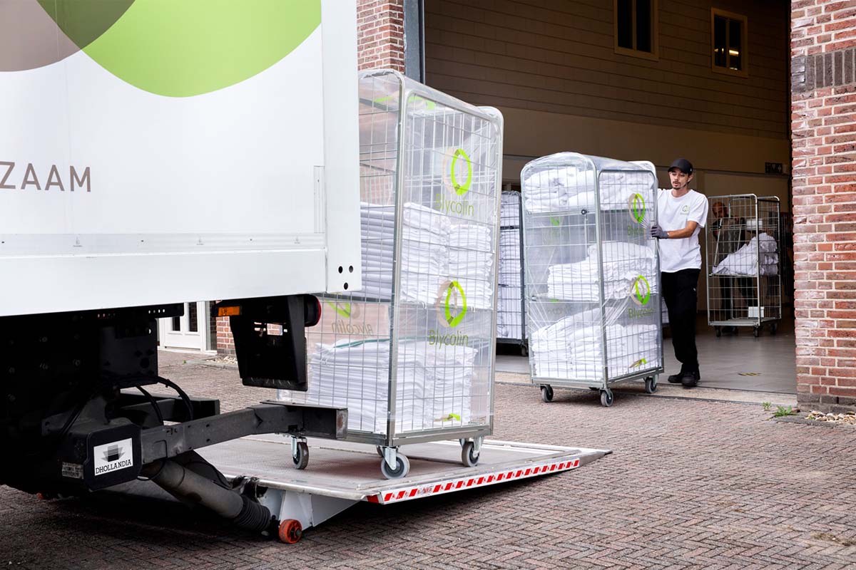 Chauffeur van Blycolin lost linnenkarren via de laadklep in Spijkenisse